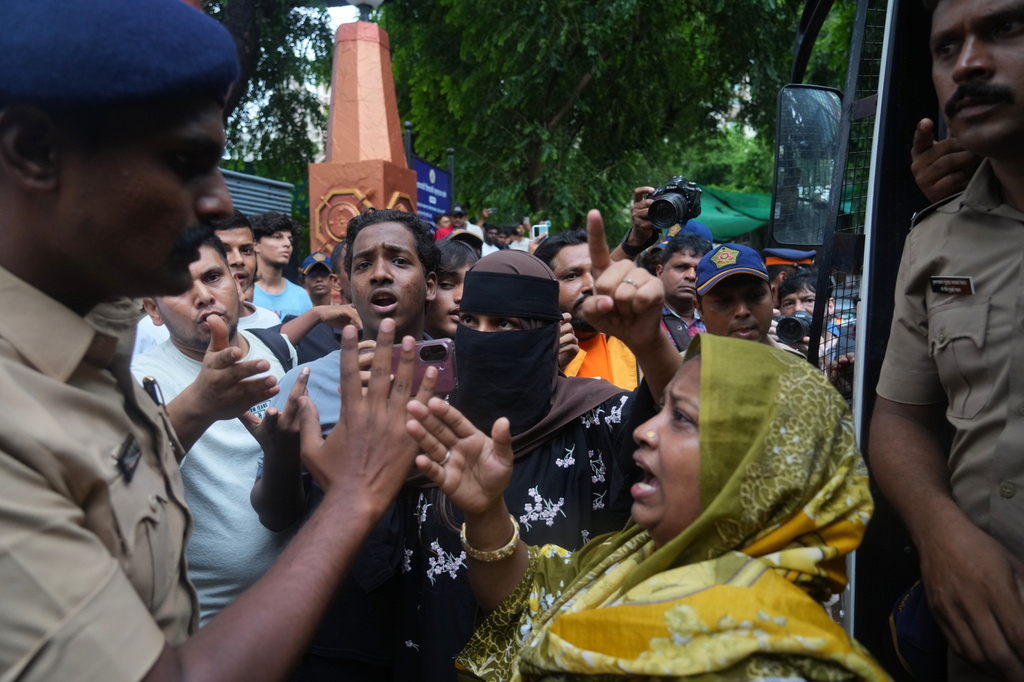 Protesters confront a police officer during a demonstration demanding educational reforms as part of the Cockroach Janta Party's ongoing protest movement in Mumbai, India, Thursday, July 23, 2026. (AP Photo/Rafiq Maqbool)