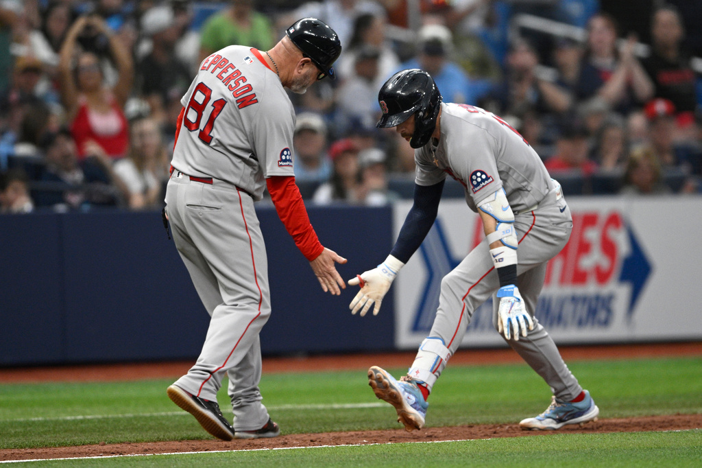 Boston Red Sox's Trevor Story, right, is congratulated by third base coach Chad Epperson (81) after hitting a solo home run during the ninth inning of a baseball game against the Tampa Bay Rays, Sunday, Sept. 20, 2026, in St. Petersburg, Fla. (AP Photo/Phelan M. Ebenhack)