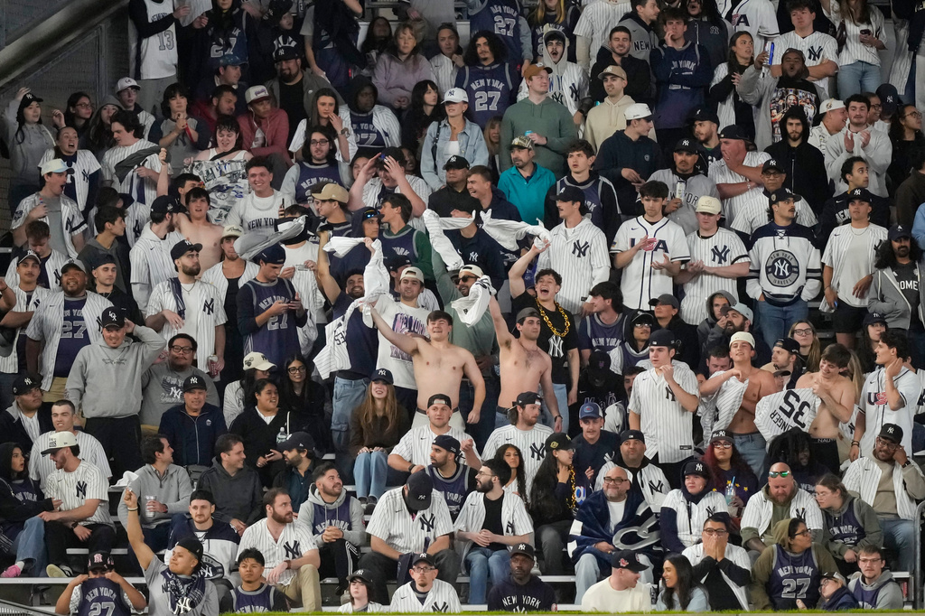 Shirtless fans of the New York Yankees react during the ninth inning of a baseball game against the Tampa Bay Rays, Friday, May 22, 2026, in New York. (AP Photo/Yuki Iwamura)