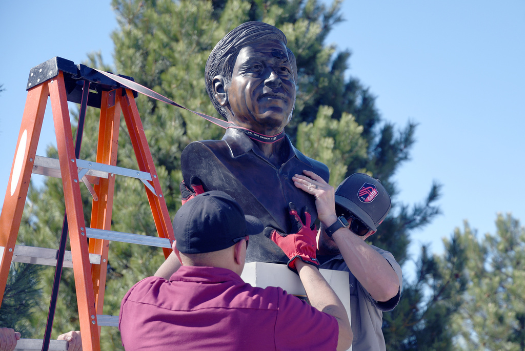 City workers remove a bust of César Chavez at César E. Chavez Park in Denver on Thursday, March 19, 2026. (AP Photo/Thomas Peipert)