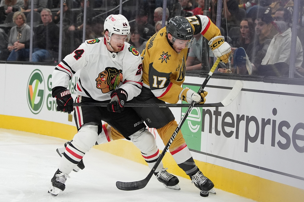 Chicago Blackhawks'Bowen Byram and Vegas Golden Knights center Marc Gatcomb (17) vie for the puck during the second period of an NHL hockey game Tuesday, Sept. 29, 2026, in Las Vegas. (AP Photo/John Locher)