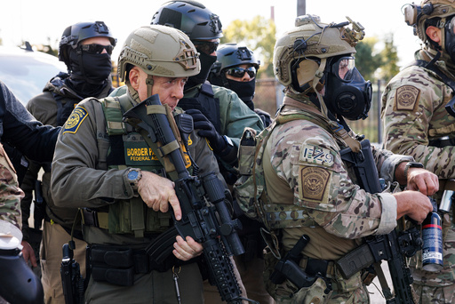 U.S. Border Patrol Commander-At-Large Gregory Bovino stands with federal immigration enforcement agents during a skirmish with protesters in Little Village neighborhood, Chicago Thursday, Oct. 23, 2025. (Anthony Vazquez/Chicago Sun-Times via AP) U.S. Border Patrol Commander-At-Large Gregory Bovino stands with federal immigration enforcement agents during a skirmish with protesters in Little Village neighborhood, Chicago Thursday, Oct. 23, 2025. (Anthony Vazquez/Chicago Sun-Times via AP)