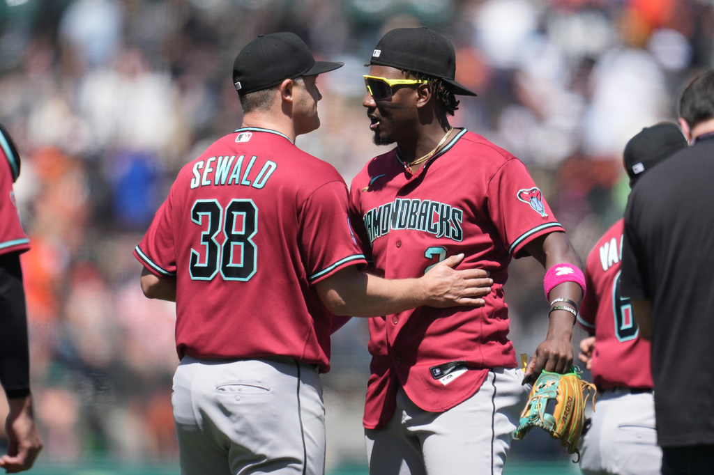 Arizona Diamondbacks' Paul Sewald (38) and Geraldo Perdomo celebrate after a baseball game against the San Francisco Giants Wednesday, May 27, 2026, in San Francisco. (AP Photo/Jeff Chiu)