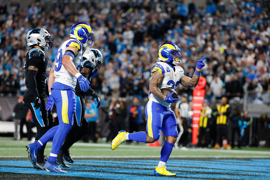 Los Angeles Rams running back Kyren Williams, right, scores a touchdown during the second half of an NFL wild-card playoff football game against the Carolina Panthers, Saturday, Jan. 10, 2026, in Charlotte, N.C. (AP Photo/Rusty Jones)