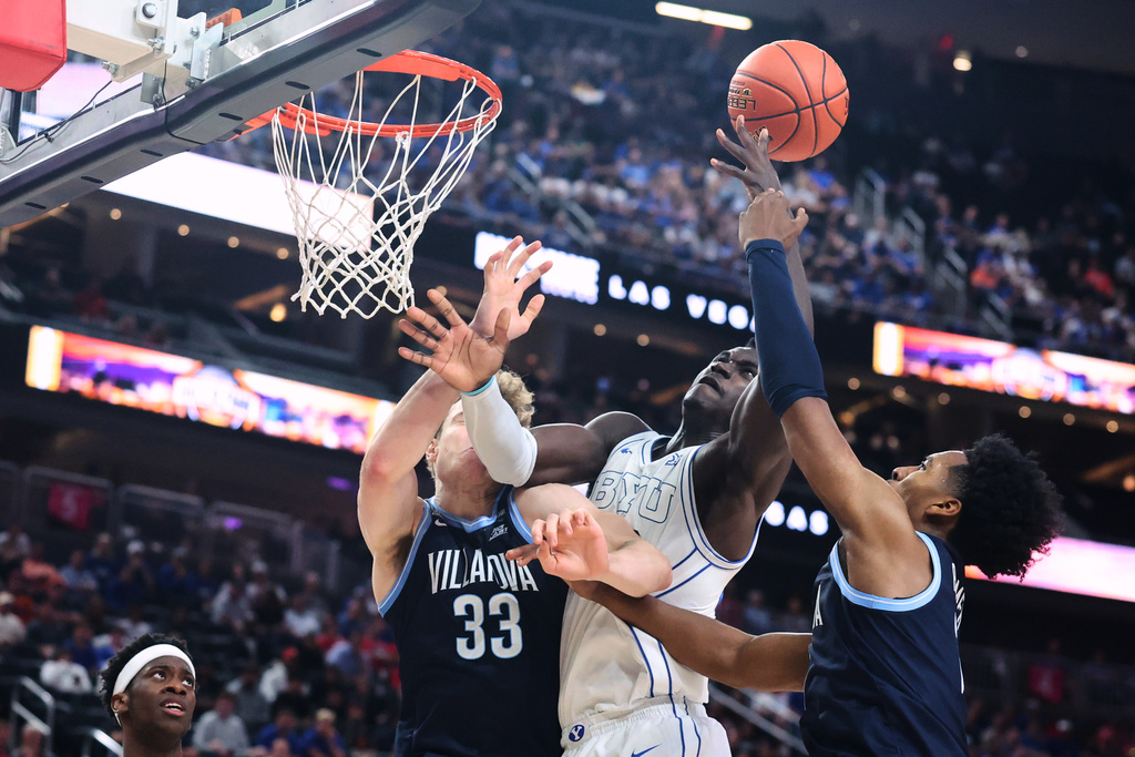 BYU forward Keba Keita, center, contests for a rebound against Villanova forward Matt Hodge (33) and guard Malachi Palmer, right, during the first half of an NCAA college basketball game, Monday, Nov. 3, 2025, in Las Vegas. (AP Photo/Ian Maule)