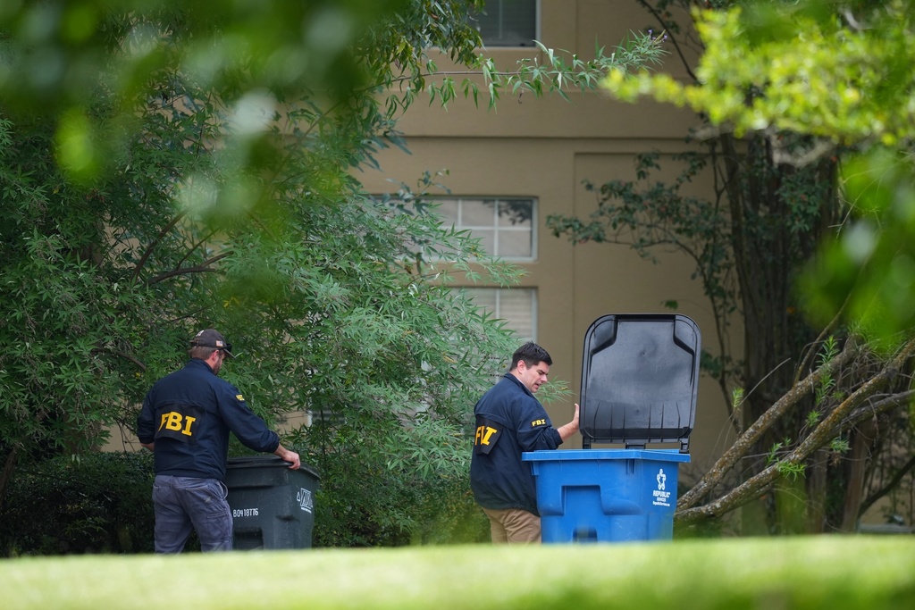 FBI agents look around a home in Fairview, Texas, that public records link to a suspected gunman at a U.S. Immigration and Customs Enforcement office in Dallas, on Wednesday, Sept. 24, 2025. (AP Photo/Julio Cortez)