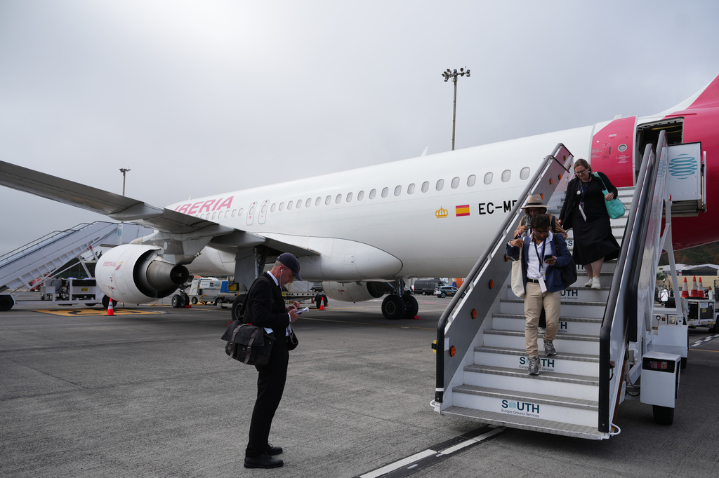 Journalists leave the papal flight after takeoff was delayed at Los Rodeos International Airport, at the Canary Islands, Spain, Friday, June 12, 2026. (AP Photo/Alessandra Tarantino)