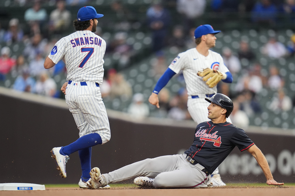 Atlanta Braves' Matt Olson, bottom, slides but is forced out at second by Chicago Cubs shortstop Dansby Swanson (7) during the first inning of a baseball game Wednesday, Sept. 3, 2025, in Chicago. (AP Photo/Erin Hooley)