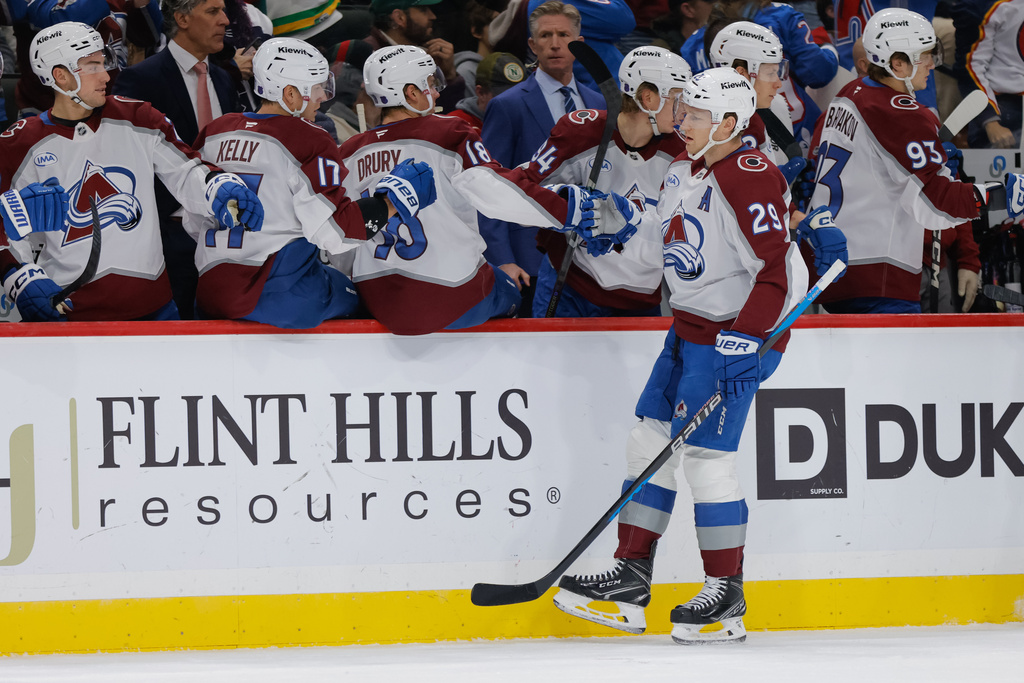Colorado Avalanche center Nathan MacKinnon (29) is congratulated by teammates after scoring during the first period of an NHL hockey game against the Minnesota Wild, Friday, Nov. 28, 2025, in St. Paul, Minn. (AP Photo/Bailey Hillesheim)