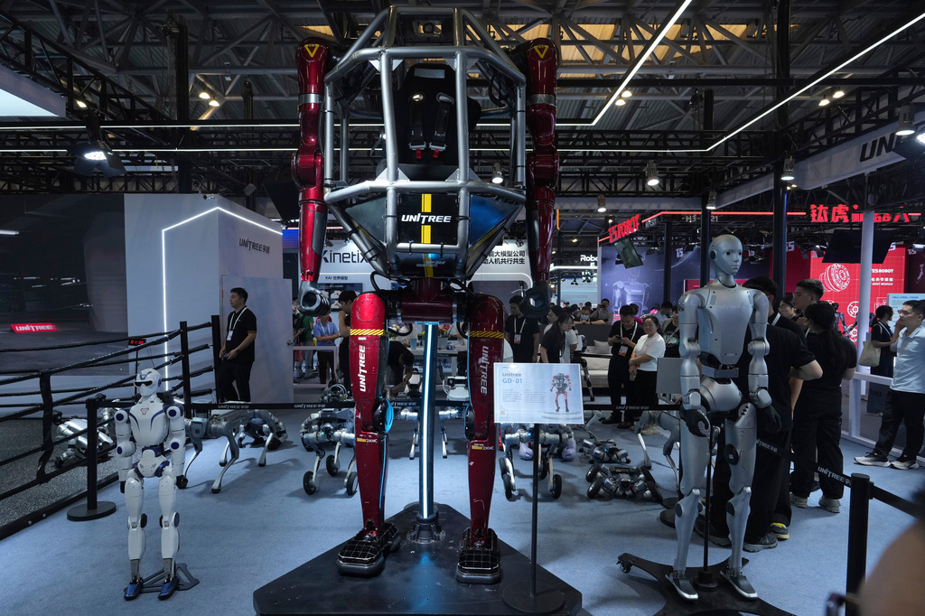 A wide range of robots are displayed at a booth for leading Chinese commercial humanoid robotics firm Unitree Robotics during the World AI Conference in Shanghai, China, on July 17, 2026. (AP Photo/Ng Han Guan)