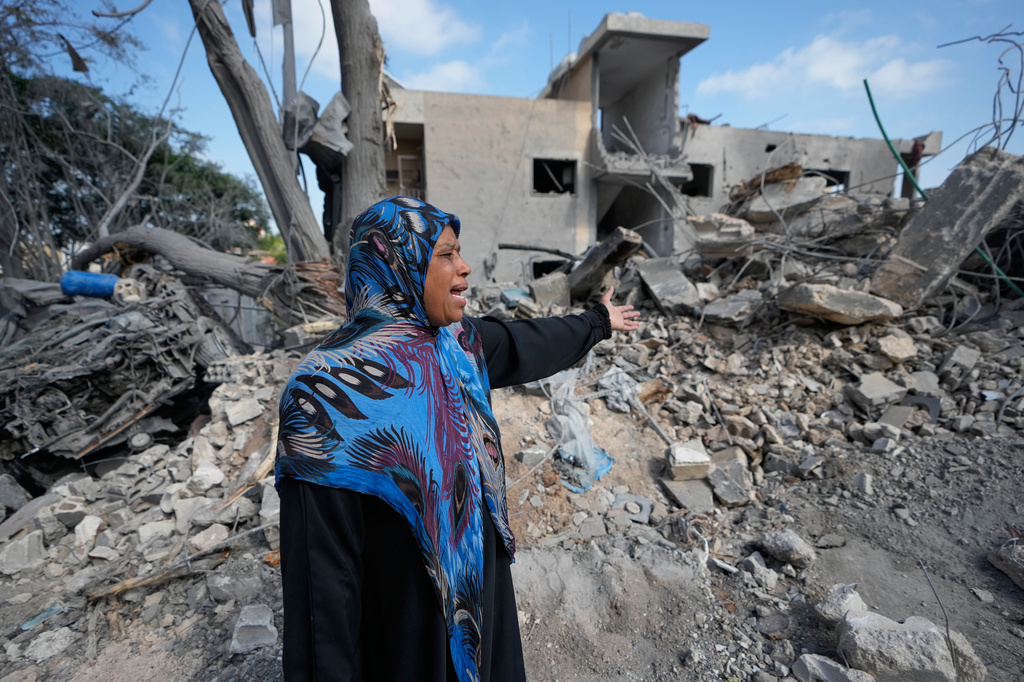 A woman gestures near the rubble of her home destroyed in an Israeli airstrike a day earlier in the southern village of Maarakeh, Lebanon, Wednesday, May 27, 2026. (AP Photo/Mohammed Zaatari)