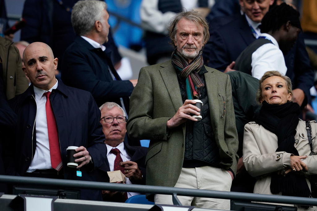 FILE - Manchster United co-owner Jim Ratcliffe stands in front of the former manager Alex Ferguson during the Premier League soccer match between Manchester City and Manchester United in Manchester, England, on Sept. 14, 2025. (AP Photo/Dave Thompson, File)