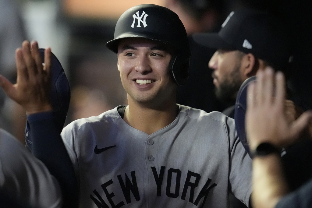 New York Yankees shortstop Anthony Volpe (11) celebrates scoring off the sacrifice fly hit by New York Yankees' Aaron Judge in the third inning of a baseball game against the Minnesota Twins, Tuesday, Sept. 16, 2025, in Minneapolis. (AP Photo/Mike Stewart)