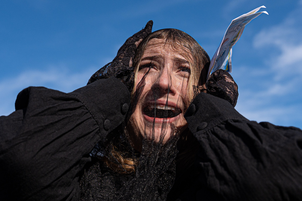 A woman wears a black mourning veil while attending a mock funeral for the penny, which was discontinued earlier this year, Saturday, Dec. 20, 2025, in front of the Lincoln Memorial in Washington. (AP Photo/Julia Demaree Nikhinson)
