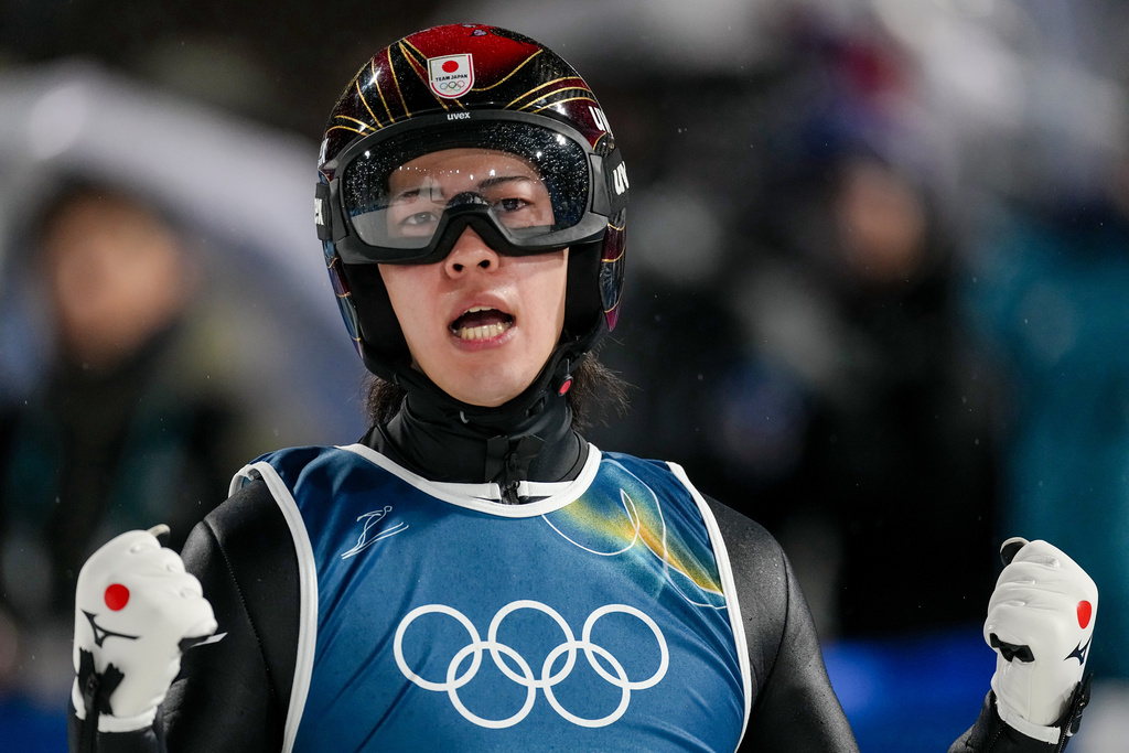 Ren Nikaido, of Japan, reacts after landing his first round jump during the ski jumping men's large hill individual at the 2026 Winter Olympics, in Predazzo, Italy, Saturday, Feb. 14, 2026. (AP Photo/Matthias Schrader)