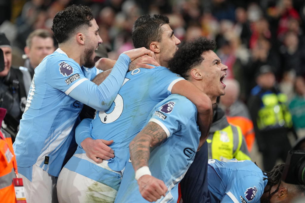 Manchester City players celebrate after a goal during the English Premier League soccer match between Liverpool and Manchester City in Liverpool, England, Sunday, Feb. 8, 2026. (AP Photo/Jon Super)