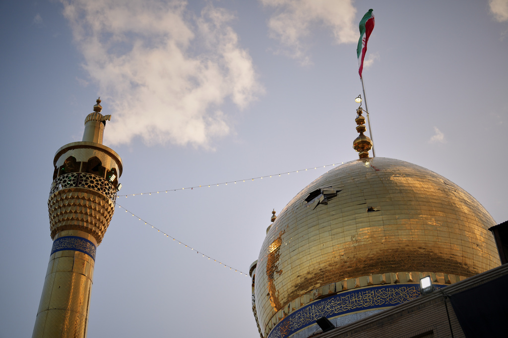 A hole is seen in the dome of the Grand Hosseiniyeh mosque that officials say was hit by U.S.-Israeli airstrikes Tuesday in Zanjan, Iran, Saturday, April 4, 2026. (AP Photo/Francisco Seco)