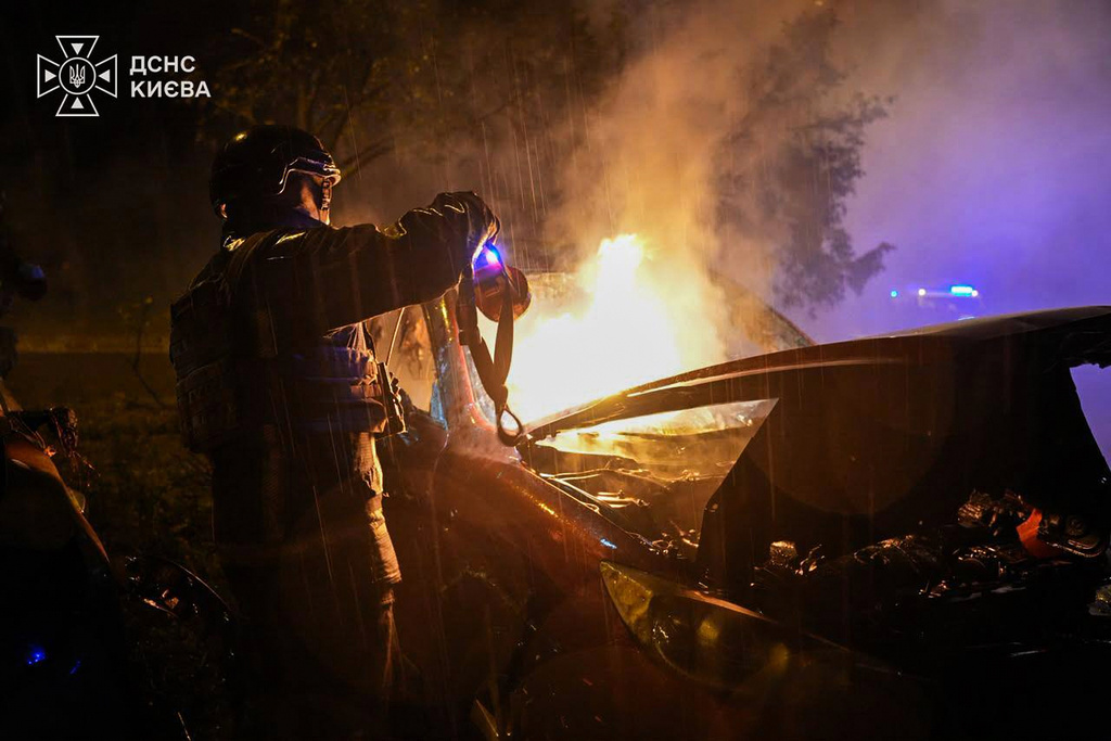 In this photo provided by the Ukrainian Emergency Services, a rescue worker checks a car destroyed following a Russian strike on Kyiv, Ukraine, Thursday, Sept. 24, 2026. (Ukrainian Emergency Service via AP)