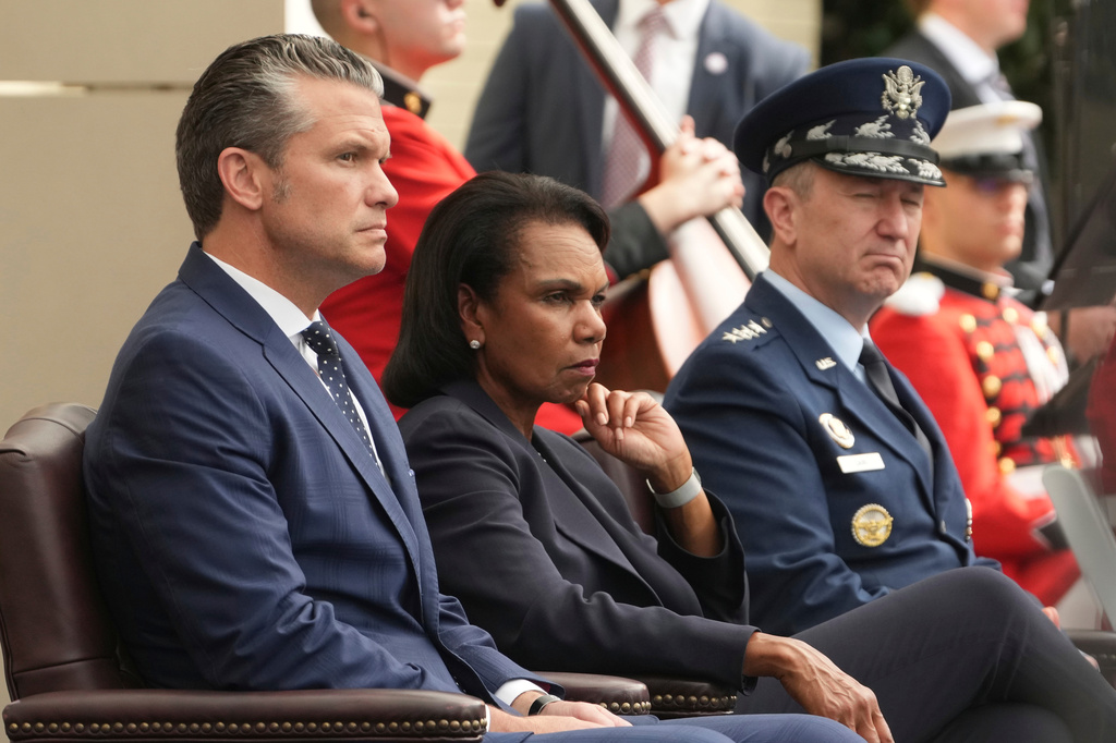 Secretary of Defense Pete Hegseth, from left, Former Secretary of State Condoleezza Rice and Chairman of the Joint Chiefs of Staff Gen. Dan Caine attend an observance ceremony on the 25th anniversary of the 9/11 attacks, Friday, Sept. 11, 2026, at the Pentagon in Washington. (AP Photo/Mark Schiefelbein)