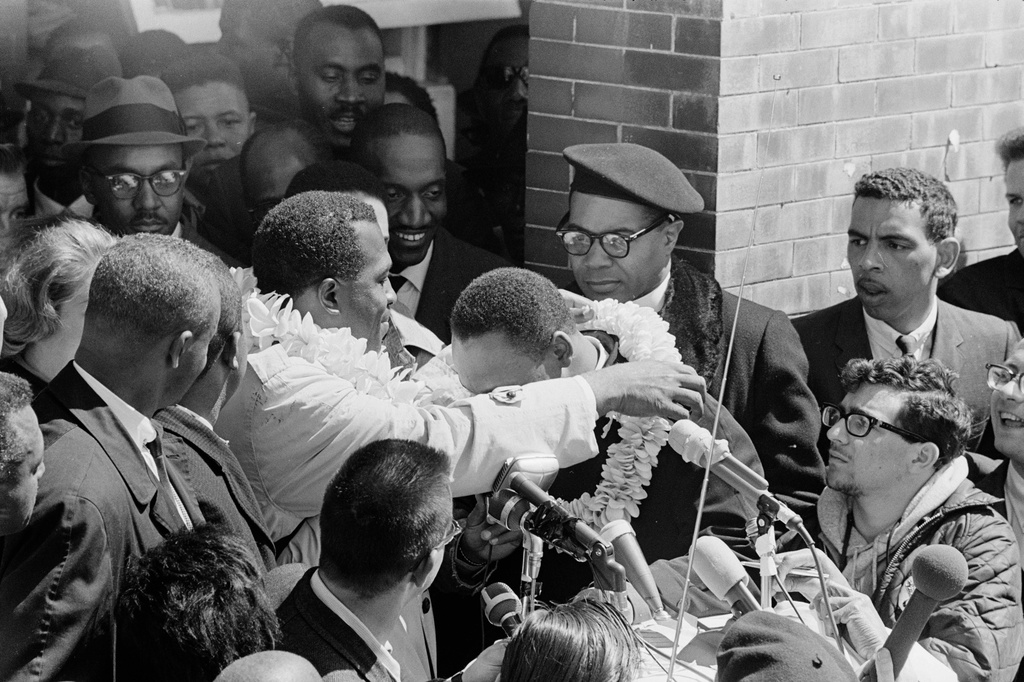 Charles Campbell, who traveled to Alabama for the march from Selma to Montgomery, placing a lei on Dr. Martin Luther King, Jr. at Brown Chapel AME in Selma, Ala., March 21, 1965. (Matt Herron/Jeannine Herron/Dept. of Special Collections and University Archives, Stanford University Libraries via AP)