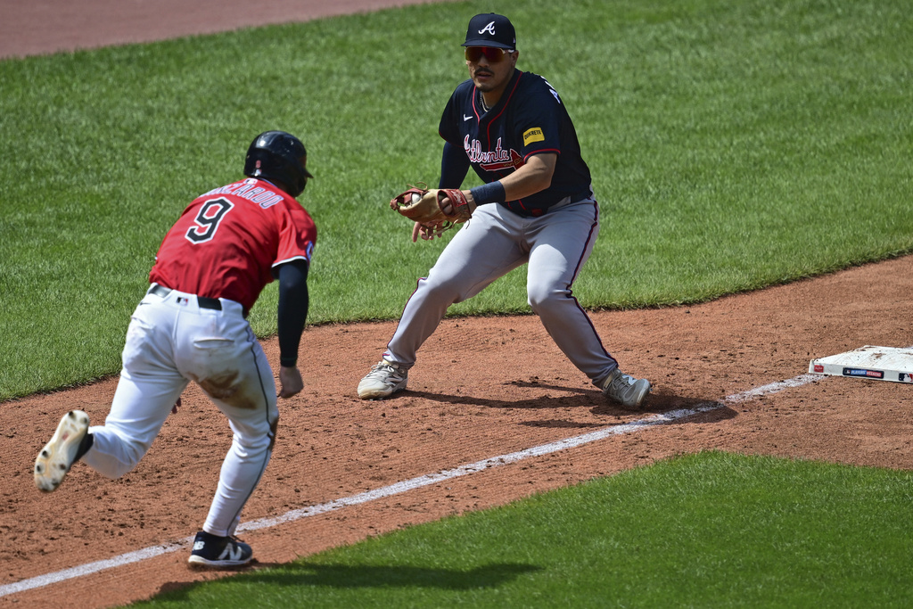Atlanta Braves third baseman Nacho Alvarez Jr., right, prepares to tag out Cleveland Guardians' Kyle Manzardo (9) during the third inning of a baseball game, Sunday, Aug. 17, 2025, in Cleveland. (AP Photo/David Dermer)