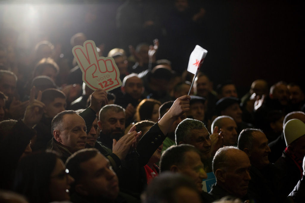 Supporters of LDK (Democratic League of Kosovo) hold a victory sign poster during election rally in the town of Shtimje on Thursday, Dec. 25, 2025. (AP Photo/Visar Kryeziu)