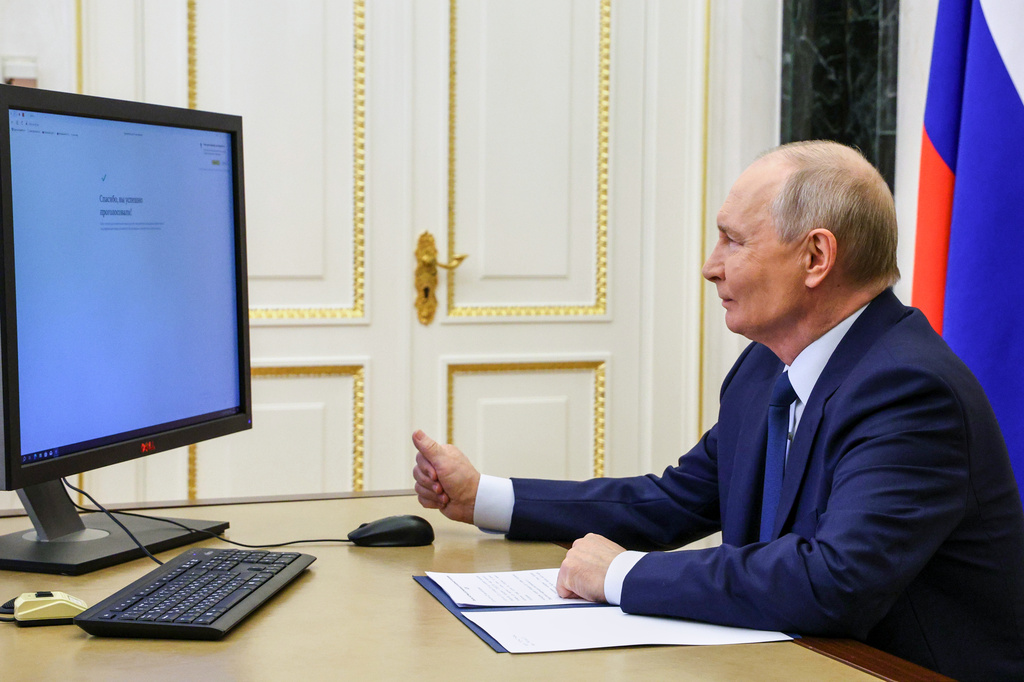 Russian President Vladimir Putin votes online in the parliamentary election, at the Kremlin in Moscow, Friday, Sept. 18, 2026. (Vyacheslav Prokofyev/Sputnik, Kremlin Pool Photo via AP)