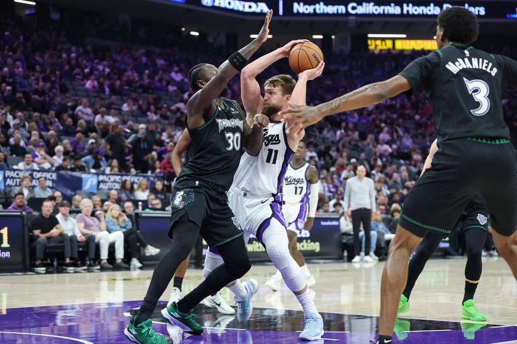 Sacramento Kings center Domantas Sabonis (11) battles in the paint with Minnesota Timberwolves forward Julius Randle (30) during the first half of an NBA basketball game Sunday, Nov. 9, 2025, in Sacramento, Calif. (AP Photo/Sara Nevis)