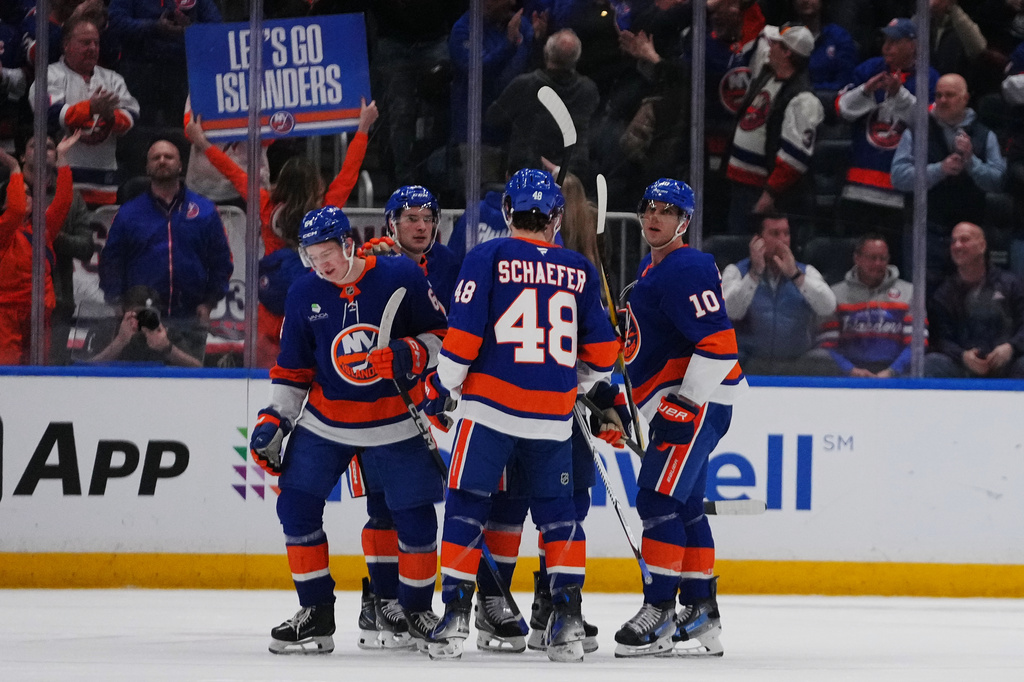 New York Islanders' Calum Ritchie, left, celebrates with teammates after scoring a goal during the third period of an NHL hockey game against the Toronto Maple Leafs Thursday, April 9, 2026, in Elmont, N.Y. (AP Photo/Frank Franklin II)