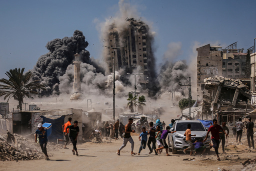 People run for cover during an Israeli airstrike on a high-rise building in Gaza City, Friday, Sept. 5, 2025, after the Israeli army issued a warning. (AP Photo/Yousef Al Zanoun) People run for cover during an Israeli airstrike on a high-rise building in Gaza City, Friday, Sept. 5, 2025, after the Israeli army issued a warning. (AP Photo/Yousef Al Zanoun)