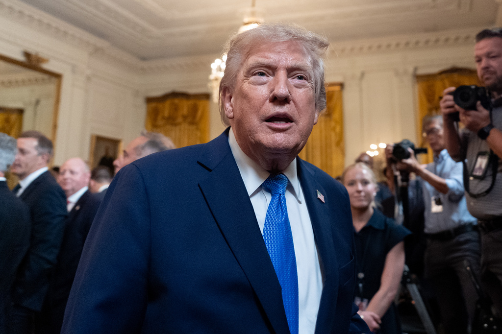 President Donald Trump speaks with a reporter as he departs after an event for Olympic athletes, coaches, staff, and representatives from Team USA in the East Room of the White House, Thursday, Aug. 6, 2026, in Washington. (AP Photo/Alex Brandon)