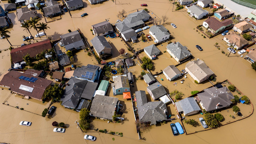 FILE - Floodwaters surround homes and vehicles in the community of Pajaro in Monterey County, Calif., on March 13, 2023. (AP Photo/Noah Berger, file) FILE - Floodwaters surround homes and vehicles in the community of Pajaro in Monterey County, Calif., on March 13, 2023. (AP Photo/Noah Berger, file)