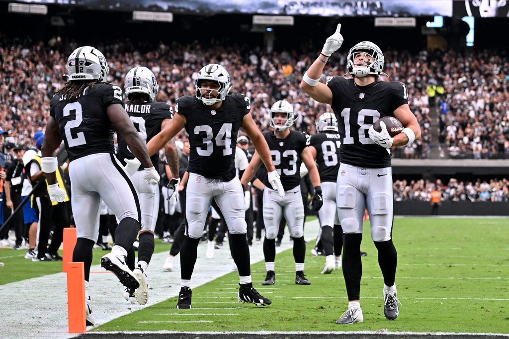 Las Vegas Raiders wide receiver Jack Bech (18) celebrates after catching a touchdown pass during the first half of an NFL football game against the Miami Dolphins, Sunday, Sept. 13, 2026, in Las Vegas. (AP Photo/David Becker)