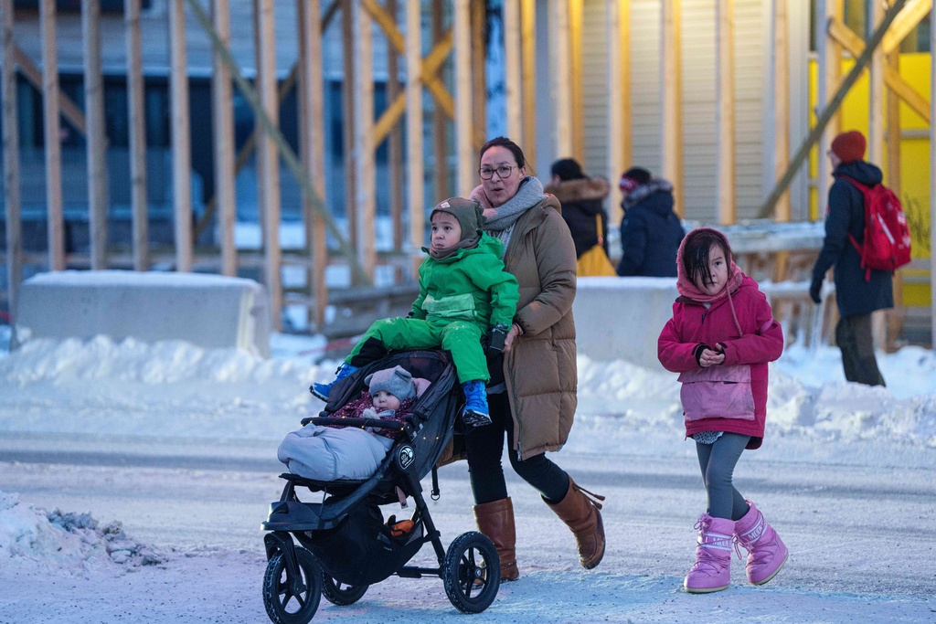 FILE - A woman pushes a stroller with her children in Nuuk, Greenland, Thursday, Jan. 15, 2026. (AP Photo/Evgeniy Maloletka, File)