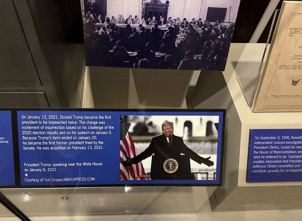A new sign at the presidential impeachment exhibit in the Smithsonian’s National Museum of American History in Washington, describes the counts against President Donald Trump in his second impeachment trial. The Senate acquitted him in both trials. The sign, seen here Aug. 26, 2025, replaces earlier, temporary text but still addresses what he was charged for. (AP Photo/Calvin Woodward)