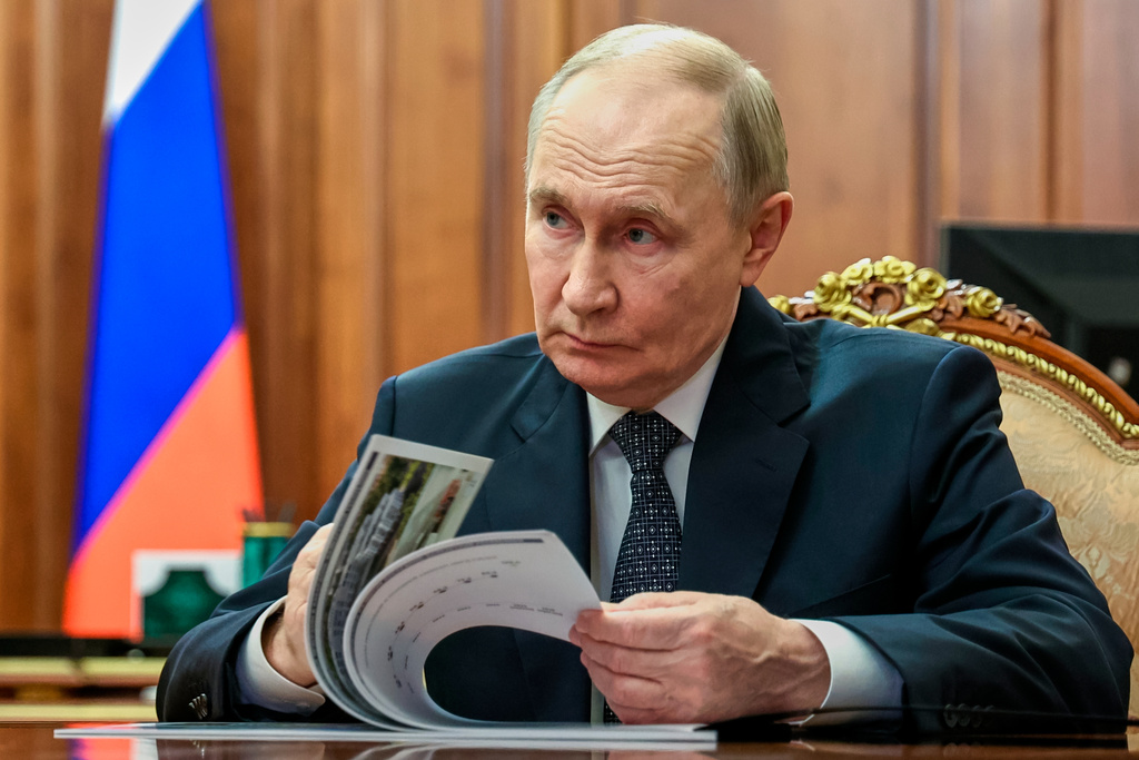 Russian President Vladimir Putin listens to the Head of the Kabardino-Balkar Republic of Russia, Kazbek Kokov, during their meeting at the Kremlin in Moscow, Russia, Tuesday, Dec. 16, 2025. (Mikhail Metzel/Sputnik, Kremlin Pool Photo via AP)