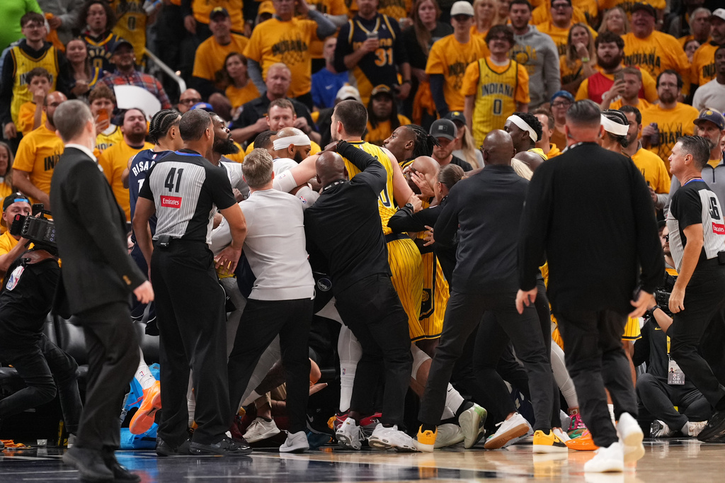 Players from the Dallas Mavericks and the Indiana Pacers scuffle after a hard foul during the first half of an NBA basketball game in Indianapolis, Friday, Oct. 23, 2026. (AP Photo/AJ Mast)