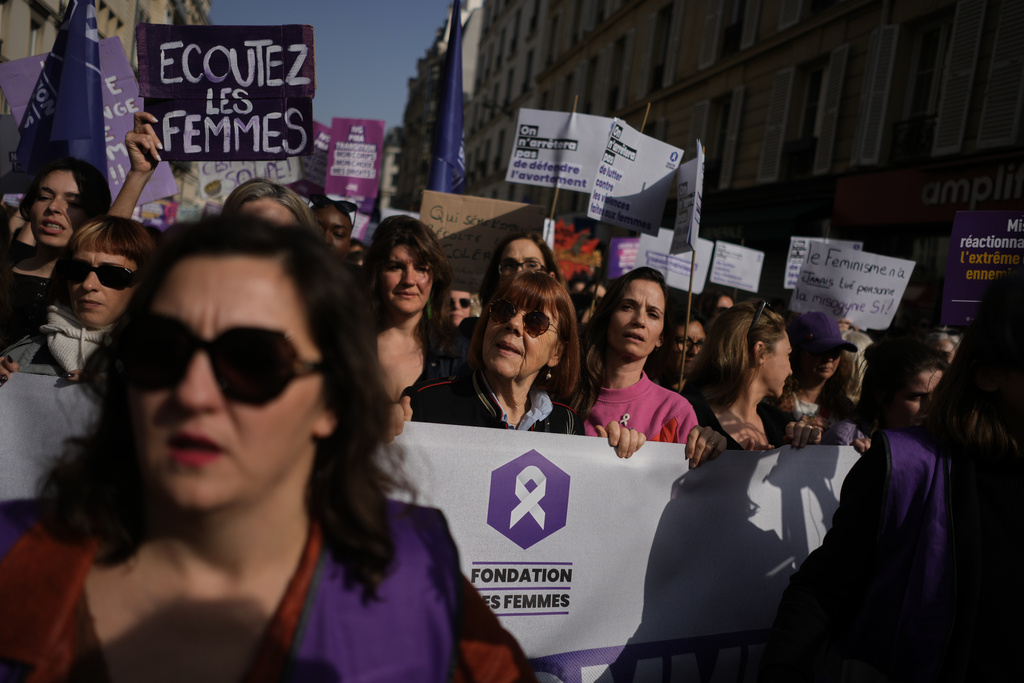Gisele Pelicot, center, attends a march to mark International Women's Day in Paris, Sunday, March 8, 2026. (AP Photo/Thibault Camus)