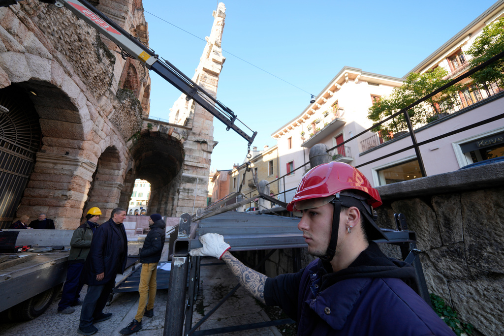 Workers build walkways for disabled access at the Arena of Verona, Italy, Wednesday, Dec. 10, 2025. (AP Photo/Luca Bruno)