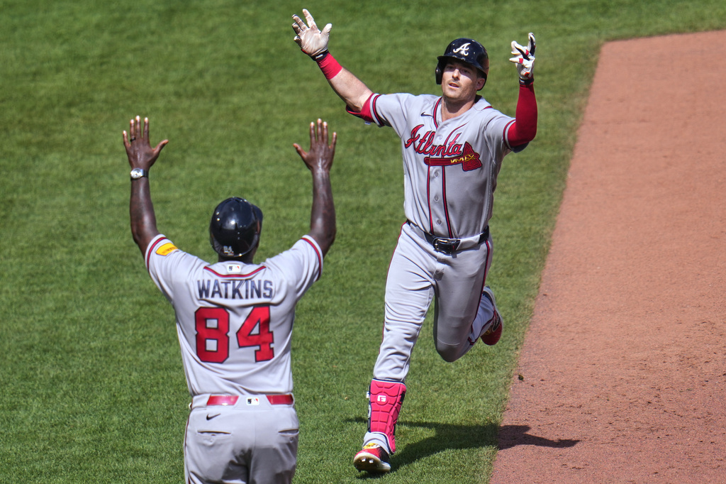 Atlanta Braves' Mike Yastrzemski, right, celebrates with third base coach Tommy Watkins as he rounds third base after hitting a grand slam home run off Pittsburgh Pirates pitcher Dennis Santana during the ninth inning of a baseball game in Pittsburgh, Thursday, July 9, 2026. (AP Photo/Gene J. Puskar)
