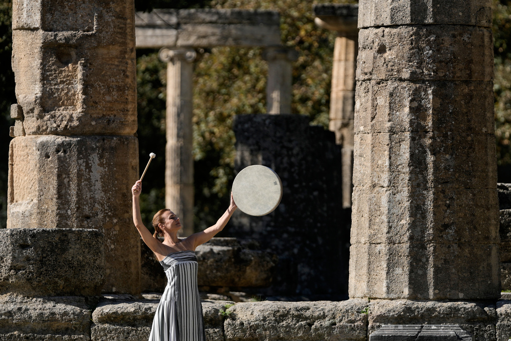 A dancer playing the role of a priestess performs during a rehearsal ahead of the flame lighting for the Milan Cortina 2026 Winter Olympics, at the Ancient Olympia site, Greece, Monday, Nov. 24, 2025. (AP Photo/Thanassis Stavrakis)