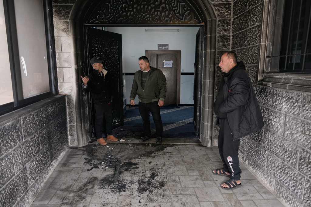 People check a fire-damaged area in the Abu Bakr al-Siddiq Mosque following, according to Palestinian authorities, an attack by Israeli settlers on the West Bank village of Tell, near Nablus, Monday, Feb. 23, 2026. (AP Photo/Majdi Mohammed)