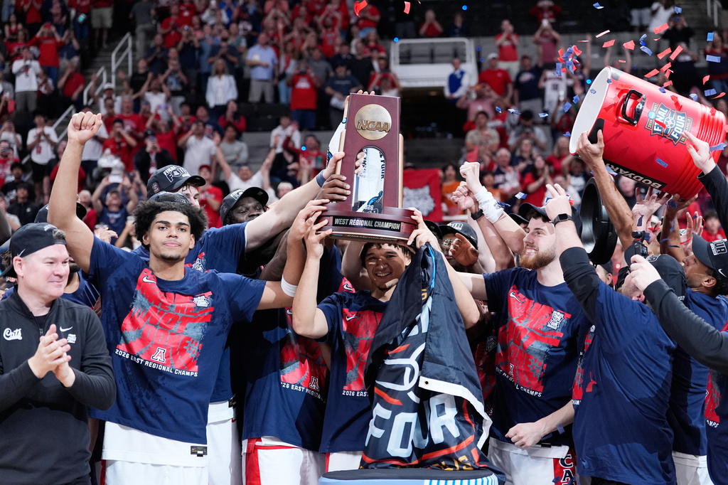 Arizona players hold a trophy after a win over Purdue in the Elite Eight of the NCAA college basketball tournament, Saturday, March 28, 2026, in San Jose, Calif. (AP Photo/Godofredo A. Vásquez)
