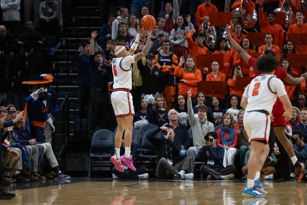 Virginia guard Jacari White (6) makes a three point shot against NC State during the first half of an NCAA college basketball game, Tuesday, Feb. 24, 2026, in Charlottesville, Va. (AP Photo/Robert Simmons)