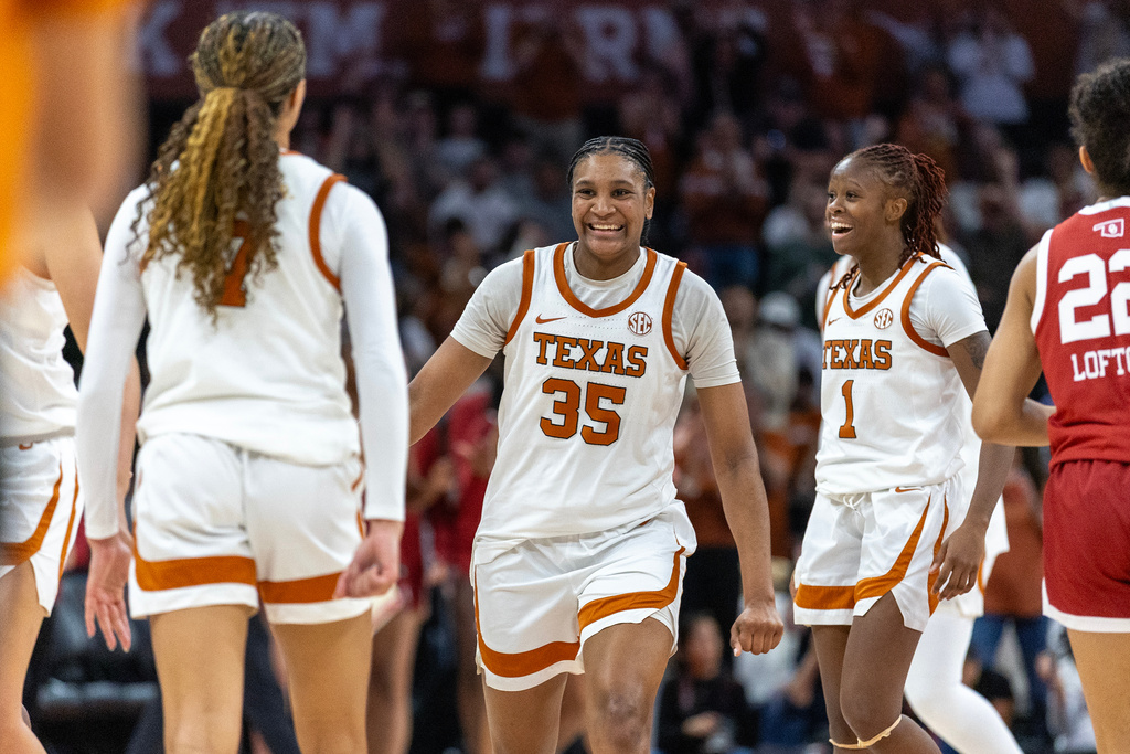 Texas guard Jordan Lee, left, forward Madison Booker (35) and guard Bryanna Preston (1) celebrate during a timeout in the second half of an NCAA college basketball game against Oklahoma, Sunday, Feb. 1, 2026, in Austin, Texas. (AP Photo/Stephen Spillman)