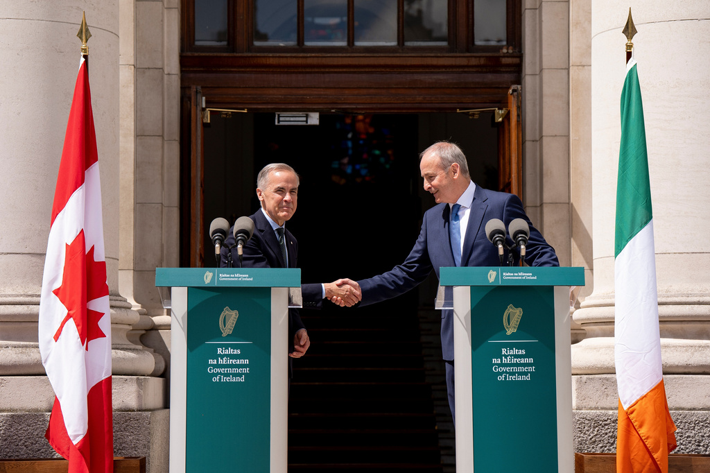 Prime Minister Mark Carney, left, shakes hands with Micheal Martin, Ireland's head of government, after giving remarks at the Government Buildings in Dublin, Ireland, on Saturday, June 13, 2026. (Christopher Katsarov /The Canadian Press via AP)