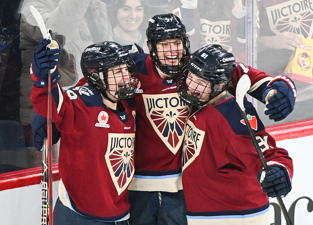 Montreal Victoire's Laura Stacey (7) celebrates with teammates Marie-Philip Poulin (29) and Maggie Flaherty (91) after scoring against the Minnesota Frost's during third-period PWHL hockey game action in Laval, Quebec, Sunday, March 1, 2026. (Graham Hughes/The Canadian Press via AP)