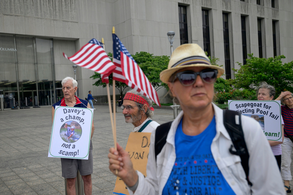 Bill Endicott, former Olympic canoeist David Hearn's coach, left, joins other to rally for Hearn, who was indicted by a grand jury for allegedly damaging the Lincoln Memorial Reflecting Pool, at D.C. Superior Court, Thursday, July 9, 2026, in Washington. (AP Photo/Rod Lamkey, Jr.)
