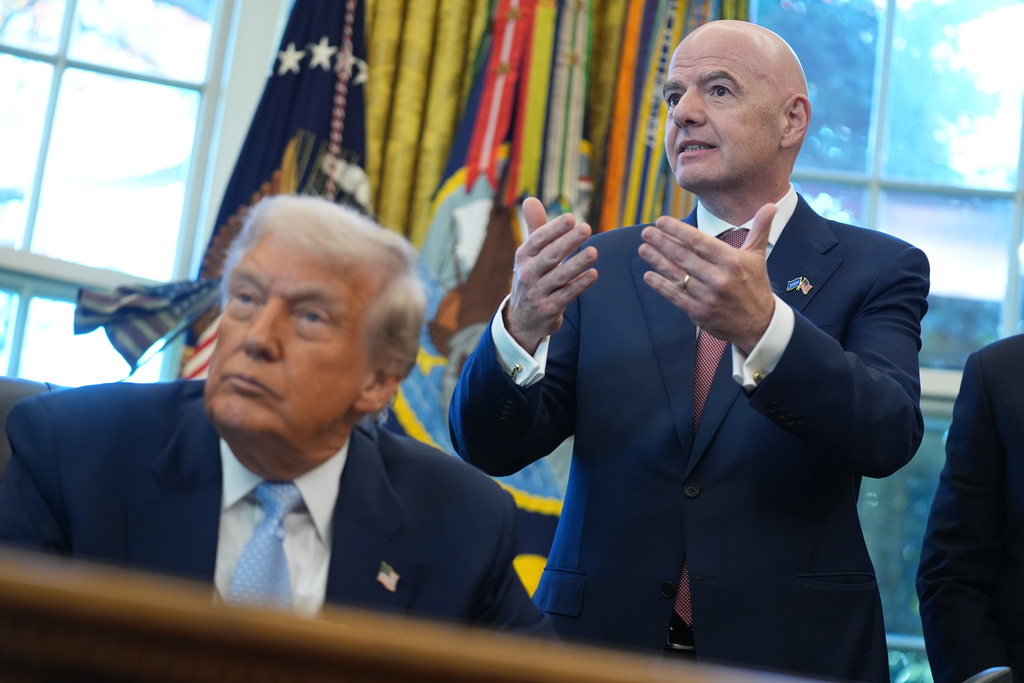 FILE - President Donald Trump listens as FIFA President Gianni Infantino speaks during a meeting with the White House task force on the 2026 FIFA World Cup in the Oval Office of the White House, Nov. 17, 2025, in Washington. (AP Photo/Evan Vucci, File)