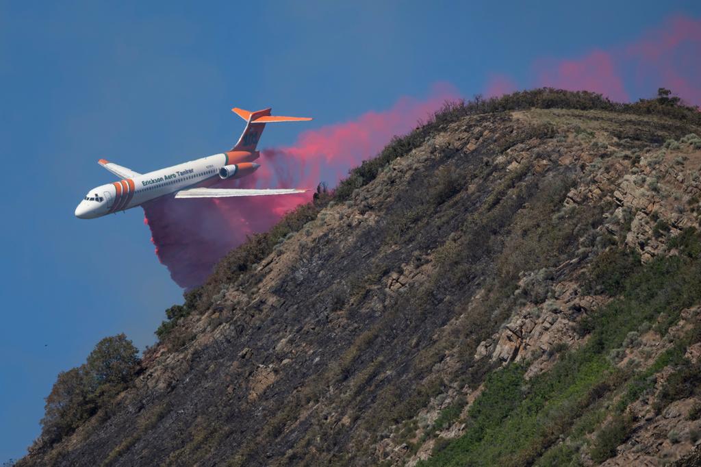 An Erickson Aero Tanker drops fire retardants on a wildfire above the University of Utah in Salt Lake City on Sunday, June 21, 2026. (Rio Giancarlo/The Deseret News via AP)
